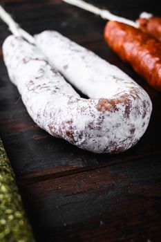 Spanish dry fuet sausages on wooden surface.