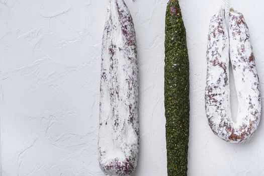 Chorizo and fuet salami on white background.