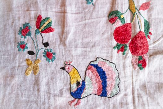 peacock hand made embroidered smooth decoration on white fabric , vintage folk embroidery in Belarus, second half of 19 century