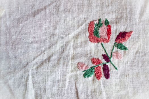 hand made embroidered smooth decoration on white fabric , vintage folk embroidery in Belarus, second half of 19 century, rose with copy space