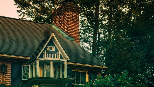 A Bird House That Looks Like a Real House on a Suburban Property