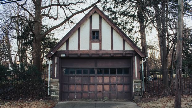 An Old-Fashioned Brown and White Garage on a Cloudy Day