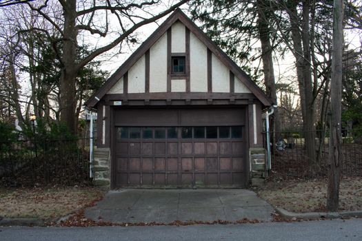 An Old-Fashioned Brown and White Garage on a Cloudy Day