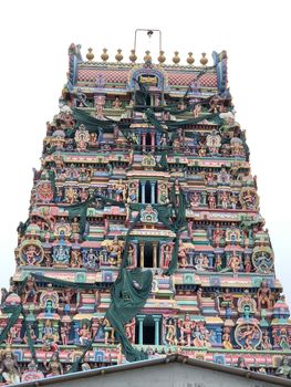 Temple with beautiful goupuram and sculptures in it with clear sky background