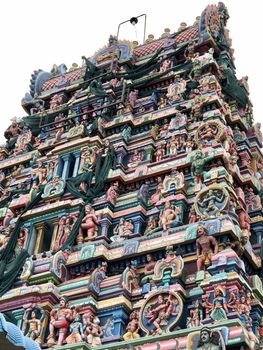 Temple with beautiful goupuram and sculptures in it with clear sky background