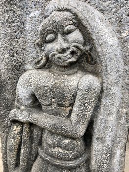 Ancient stone carvings of beautiful sculptures found in the temple in Tamilnadu. Beautiful bas-relief sculptures carved in the granite stone walls.