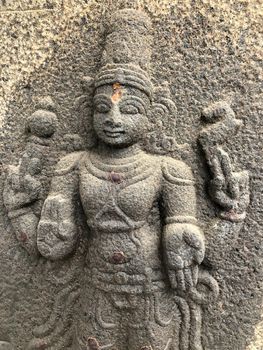 Ancient stone carvings of beautiful sculptures found in the temple in Tamilnadu. Beautiful bas-relief sculptures carved in the granite stone walls.