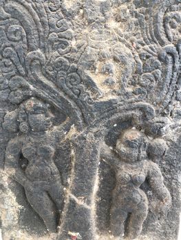 Ancient stone carvings of beautiful sculptures found in the temple in Tamilnadu. Beautiful bas-relief sculptures carved in the granite stone walls.