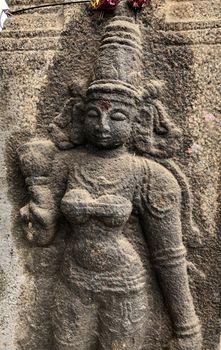 Ancient stone carvings of beautiful sculptures found in the temple in Tamilnadu. Beautiful bas-relief sculptures carved in the granite stone walls.