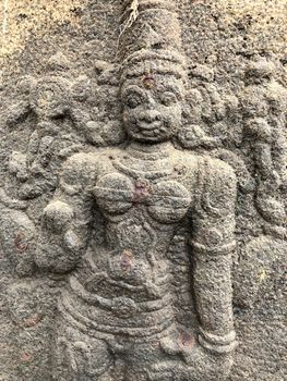 Ancient stone carvings of beautiful sculptures found in the temple in Tamilnadu. Beautiful bas-relief sculptures carved in the granite stone walls.