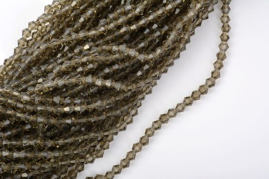 Beautiful beige Glass Sparkle Crystal Isoalted Beads on white background. Use for diy beaded jewelry. Space for text