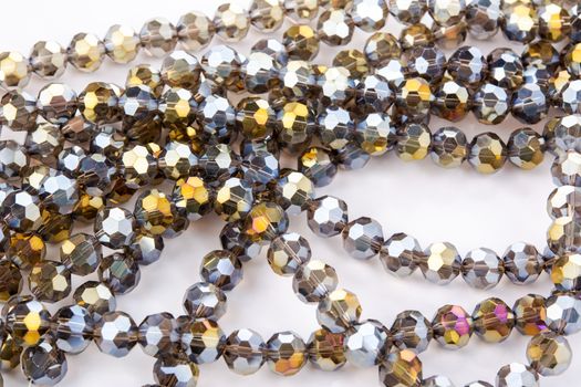 Beautiful gold beige brown Glass Sparkle Crystal Isoalted Beads on white background. Use for diy beaded jewelry. Space for text