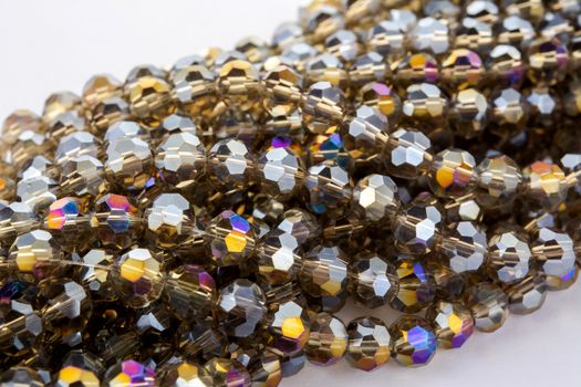 Beautiful gold beige brown Glass Sparkle Crystal Isoalted Beads on white background. Use for diy beaded jewelry. Space for text