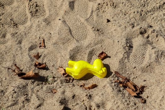 Colorful plastic children toys in sandbox at a playing ground