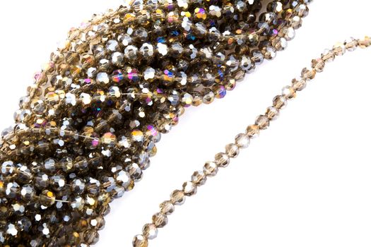 Beautiful gold beige brown Glass Sparkle Crystal Isoalted Beads on white background. Use for diy beaded jewelry. Space for text