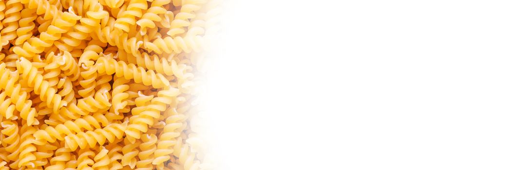 Fusilli spaghetti pattern background with copy space on the right.
