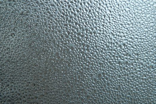 Bright grey color glassy texture, with water drops on it. Water drop glassy background