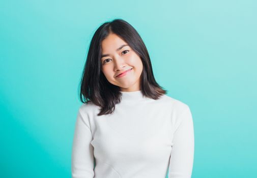 Portrait of Asian teen beautiful young woman Wear a white T-shirt smile clean skin, female beauty face concept, studio shot isolated on a blue background