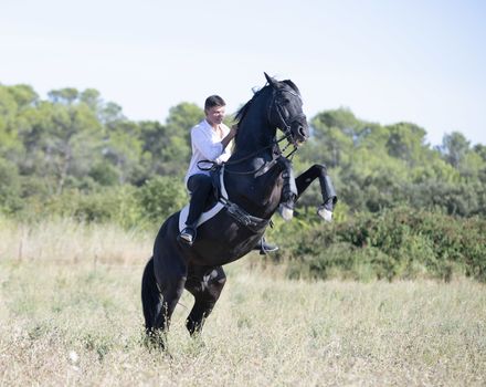  riding teenager are training her black horse