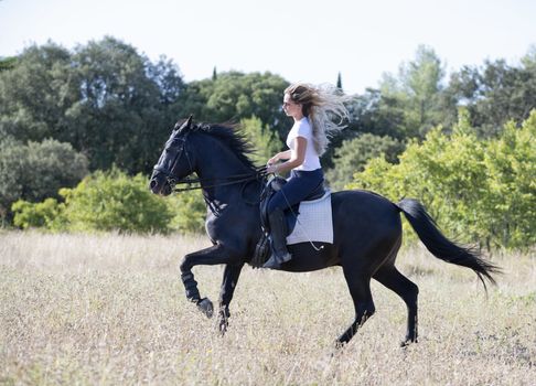  riding girl are training her black horse