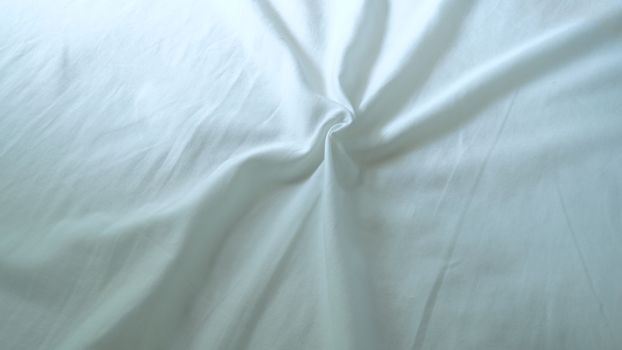 The surface wrinkles of the white bedding in the hotel.