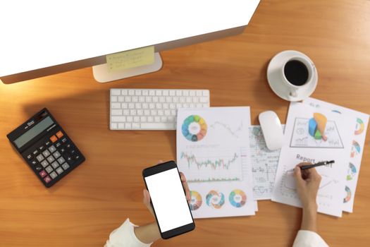 Top view Blank of smart phone and screen computer PC with blur document on office desk. Business and finance concept.