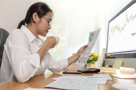 Asian business women working at home online meeting with video conference on computer. Business people using computer online meeting and speaking with team group.