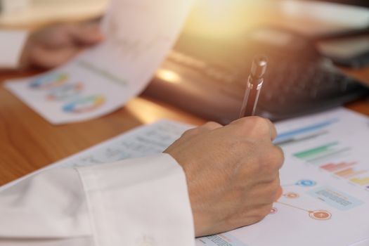 Close up hands of business women use pen writing chart on paper. Business people analysis graph chart plan. Business and financial concept