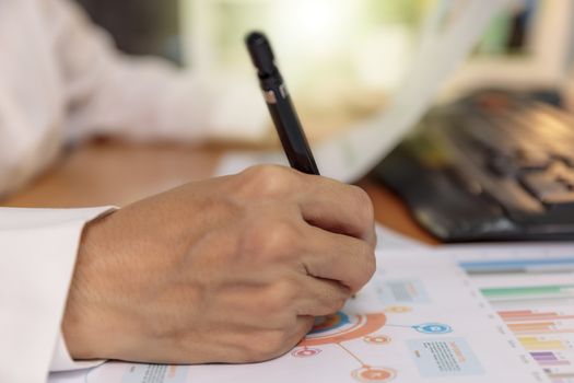 Close up hands of business women use pen writing chart on paper. Business people analysis graph chart plan. Business and financial concept