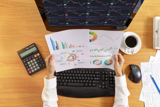 Business and financial concept  Top view hands of business women holding report chart. Hands of business people holding chart and analysis graph on computer screen.