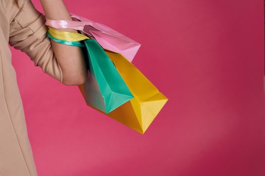 Multicolored packages Shopping lifestyle pink background. High quality photo