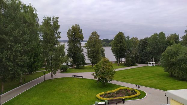 Panorama of a beautiful green park near lake.