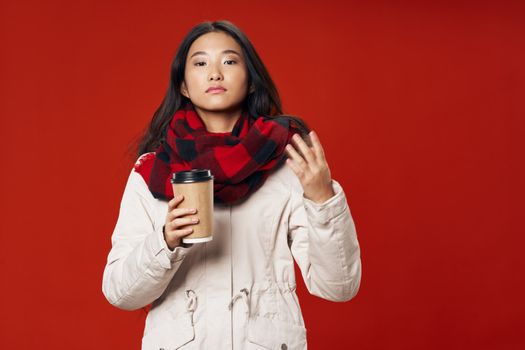 woman hot cup of drink coffee checkered scarf winter red isolated background model elegant style