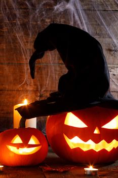 Jack O Lantern Halloween pumpkin with witches hat , spiders on web and burning candles