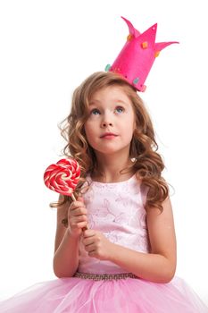 Beautiful little candy princess girl in crown with big pink heart lollipop