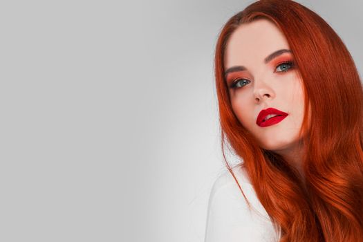 Beautiful Woman with Red Hair and bright makeup