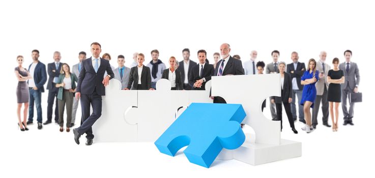 Business teamwork and cooperation concept . Portrait of group of business people with giant puzzle pieces . Partnership and collaboration concept, studio isolated on white background