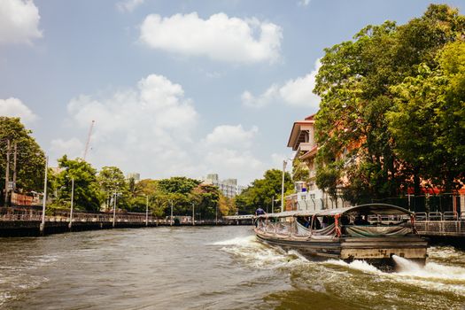 Bangkok, Thailand - April 21 2018: Boat travel in the canals of Bangkok on a hot sunny day