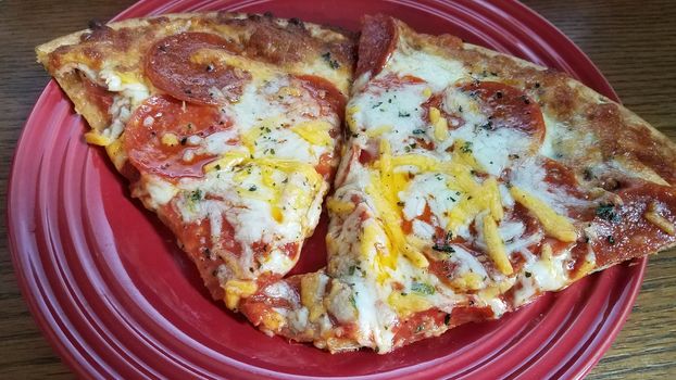 pepperoni and cheese slices of pizza on red plate