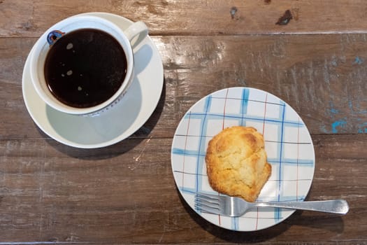 Cookie and cup of coffee on wooden background