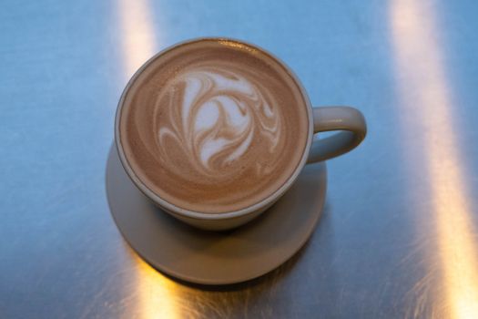 Cup of coffee with latte art on table