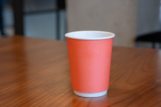 Paper cup on wooden table