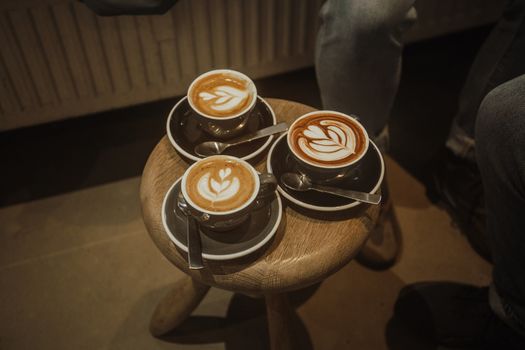 Three cups of coffee on wooden table