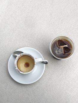 Two cups of coffee on white table