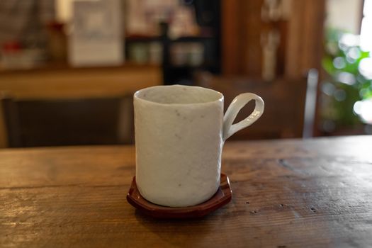 White mug on wooden table