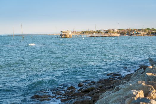 Fishing huts with typical italian fishing machine, called "trabucco",Lido di Dante, fiumi uniti Ravenna near Comacchio valley.