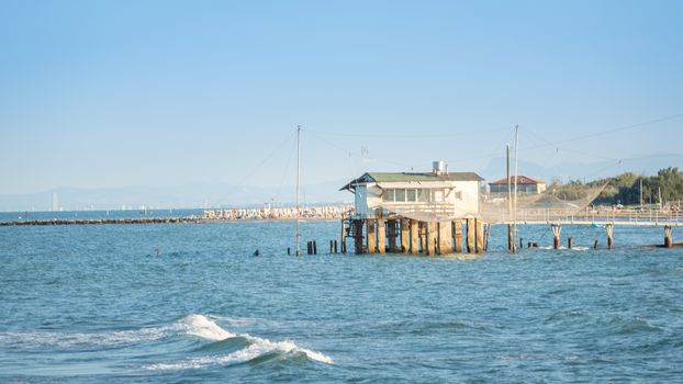 Fishing hut with typical italian fishing machine, called "trabucco",Lido di Dante, fiumi uniti Ravenna near Comacchio valley.