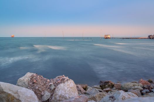 Fishing hut with typical italian fishing machine called "trabucco",at sunset ,long exposure photo,Lido di Dante, fiumi uniti Ravenna near Comacchio valley.