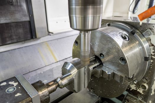 unadorned photo of automated milling metal part on vertical cnc machine
