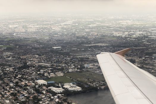 Flight and view over Bangkok in Thailand with nice city panorama from the airplane.